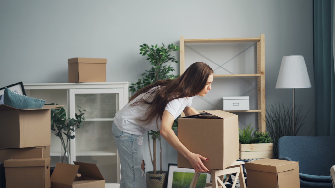 A carefully packed home mid-move, boxes labeled and furniture protected